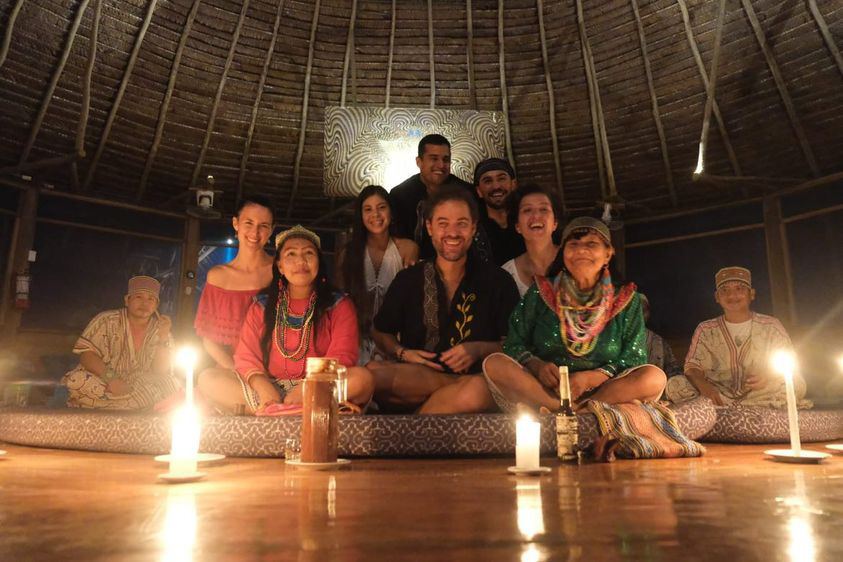 A ceremony group gathered with the maestros by candlelight