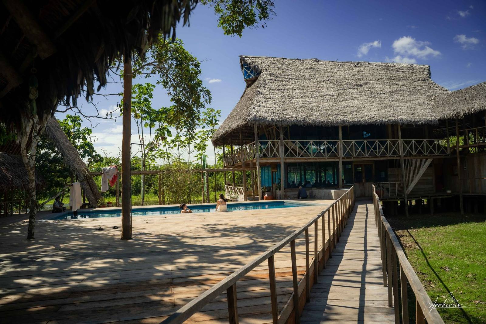 A thatched maloca at the end of a raised boardwalk