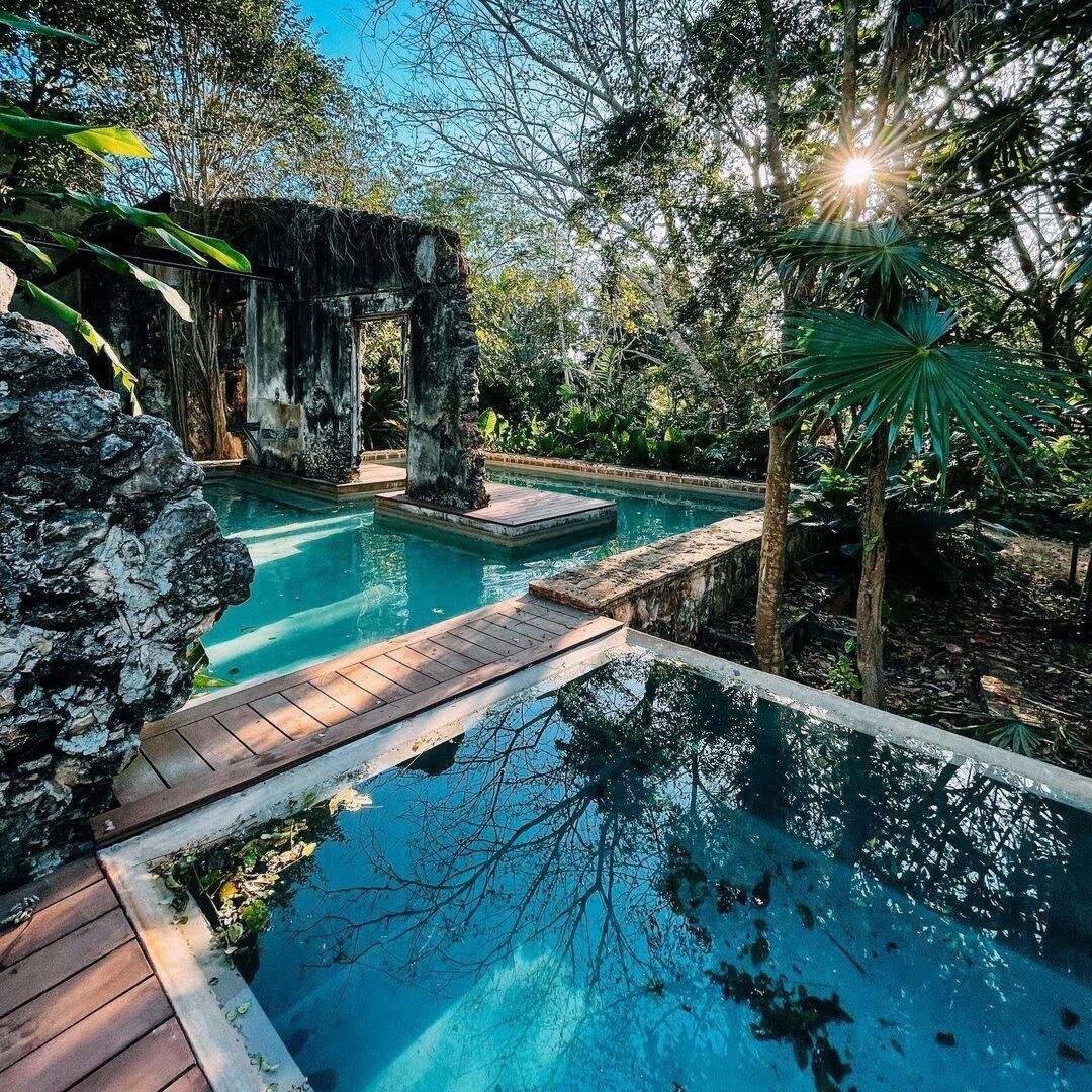 Ruins of the old hacienda framing its turquoise pools